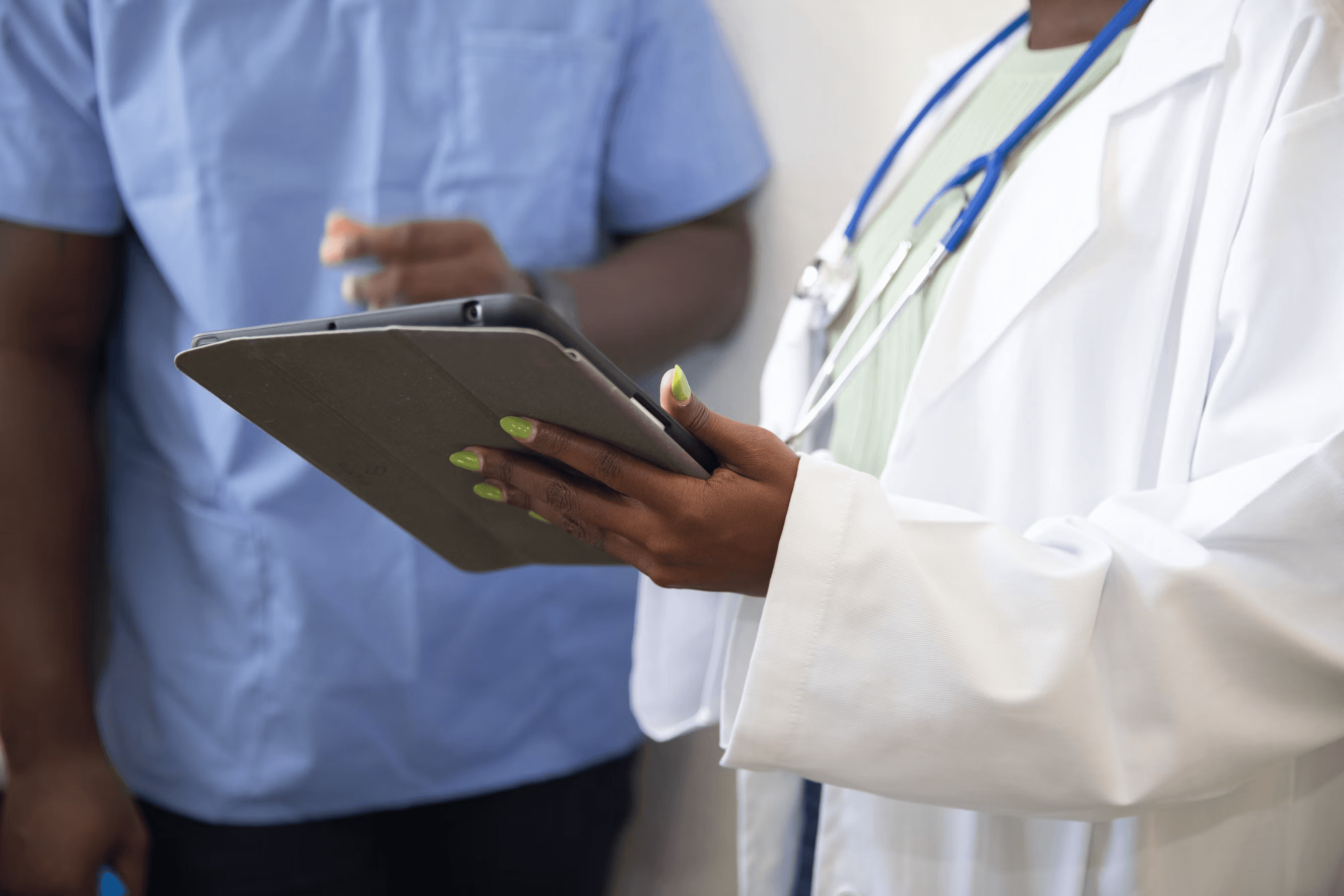 Clinician reviewing a tablet during a patient visit
